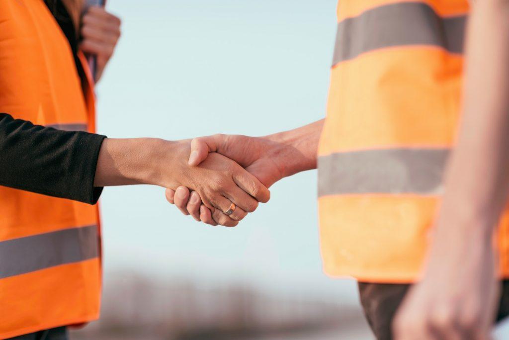 Architects handshaking after a successful paving and tiling installation.